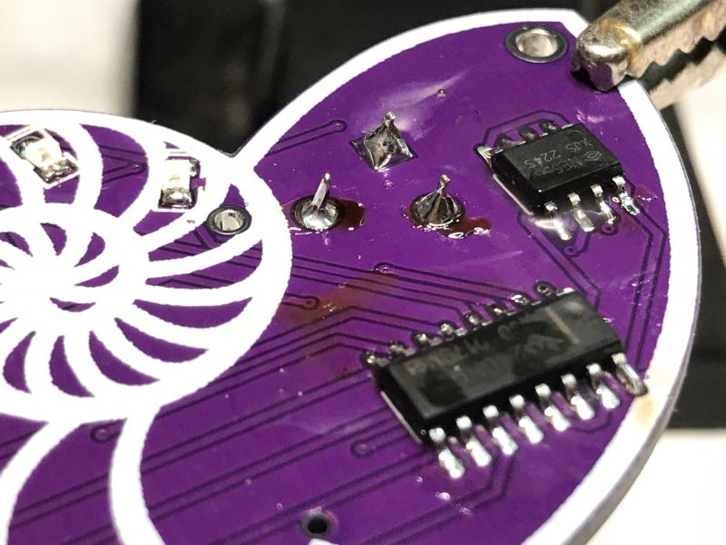 PCB with Surface-Mounted Components Close-up of a purple PCB with SMD components.