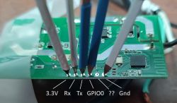 Close-up of a circuit board with labeled pins: 3.3V, Rx, Tx, GPIO0, unknown, Gnd, with connected wires.