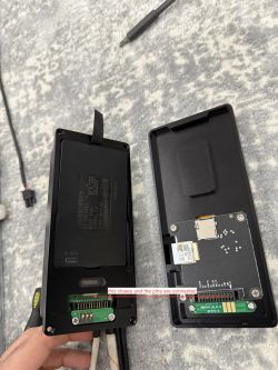 Open cases of two electronic devices with visible circuit boards and connectors.