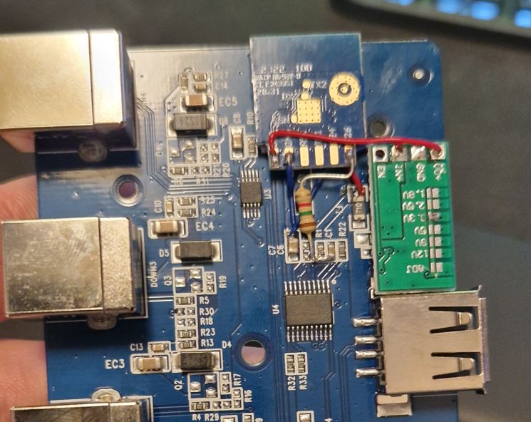 Electronic Module on Circuit Board Photo showing a circuit board with electronic modules and a resistor on a wire.
