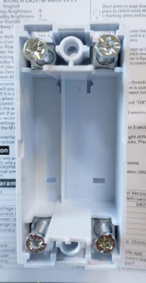View of the inside of a plastic enclosure with four mounted screw terminals.