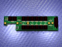 Image of a green printed circuit board with several buttons and electronic components.
