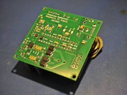 Raspberry Pi Power Supply Board by Radosław R. Assembled PCB with various electronic components on a blue work surface