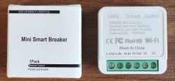 Box labeled “Mini Smart Breaker” next to a white Wi‑Fi mini smart switch with a green screw terminal block