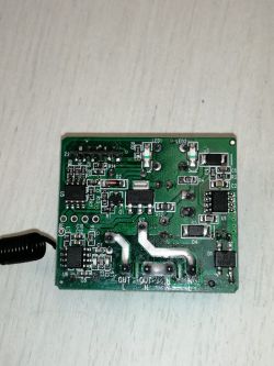A printed circuit board with various electronic components, including a coil and LEDs.