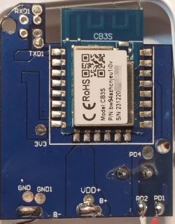 Close-up view of an electronic module on a blue printed circuit board.