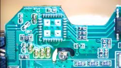 Close-up of a printed circuit board with various electronic components and visible pins.