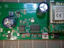 Circuit Board with Electronic Components Circuit board with electronic components, including two capacitors and two integrated circuits.