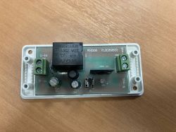 Open casing of Sonoff WHD06 V1.2 smart switch with visible electronic components.