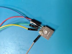 ESP-C2 module with connected colored wires.