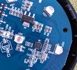 Close-up of blue PCB with LEDs and various small electronic components