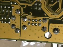 Image of a circuit board with soldered components.