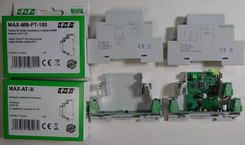 Zdjęcie przedstawia dwa przetworniki pomiarowe temperatury, ich opakowania oraz rozłożone obudowy z widoczną elektroniką.
