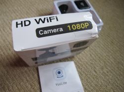 Mini HD WiFi 1080P Camera Packaging and YsxLite Manual Photo of a mini spy camera HD WiFi 1080P package and YsxLite manual on a carpet.
