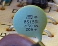 8S150L Thermistor on Circuit Board Close-up of a green electronic component labeled 8S150L on a circuit board.