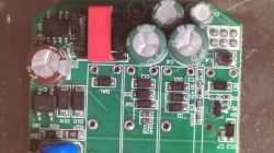 Close-up of a PCB with electrolytic capacitors, 4R7 inductor, and SMD components
