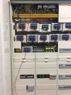 View of an electrical cabinet with installed Shelly controllers.