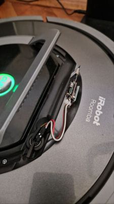 iRobot Roomba vacuum with exposed small circuit board and red, white, and black wires