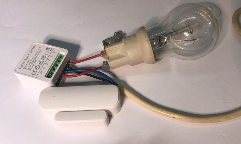 Zigbee Smart Switch with Light Bulb and Door Sensor Zigbee Smart Switch connected to a light bulb and door sensor.