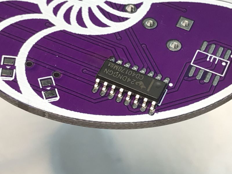 PCB with SMD Components PCB with a surface-mounted SMD chip on a purple background.