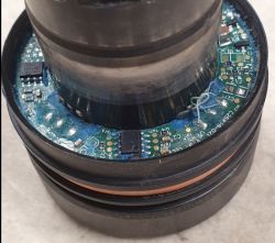 Zbliżenie na element elektroniczny z widocznymi układami scalonymi i połączeniami na płytce.
