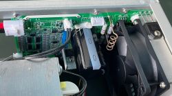 Interior of a Korad power supply showing a circuit board and a fan.