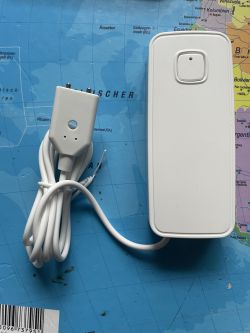WiFi Water Leakage Detector WiFi water leakage detector with a white sensor and cord on a map background.