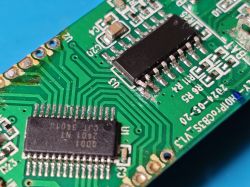 Circuit Board with Integrated Circuits Close-up of a green circuit board with two visible integrated circuits.