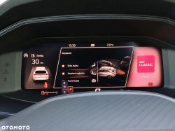 Car digital instrument cluster showing “Assistants” menu, 30 km range, and RMF Classic on the display