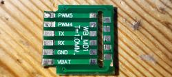 Printed circuit board with pin labels on a wooden background