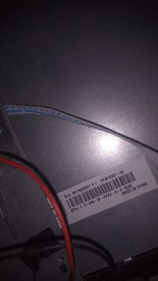 LCD Panel MT185GW01 Label Inside TV Close-up of a TV's metal casing with a visible signal ribbon cable and an LCD panel label MT185GW01.