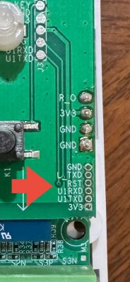 UART Pins on PCB Close-up of a PCB with pin markings and a red arrow pointing to the UART section.