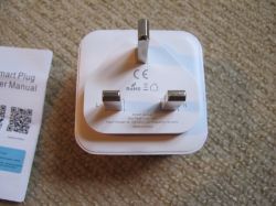 Tuya Smart Plug with Energy Metering Smart plug with three prongs and an instruction manual.