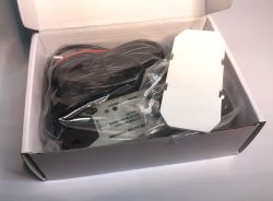 Contents of the ATLO-GDC2-TUYA Garage Door Controller Set ATLO-GDC2-TUYA garage door controller set in an open box with accessories and a long cable in a plastic bag.