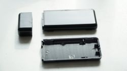 Parts of a black resin USB drive casing