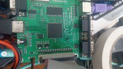 Photo of a green circuit board with various connectors and wires.