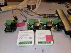 Smart switches and programming adapter setup Set of Mini Smart Switch modules and circuit boards on a workbench