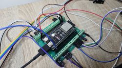 Microcontroller with wires on a wooden table.