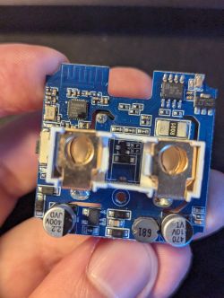 Circuit Board with Electronic Components A circuit board held in hand with various electronic components.