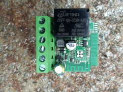 Relay module with screw terminal and SMD components Relay module with electronic components on stone background