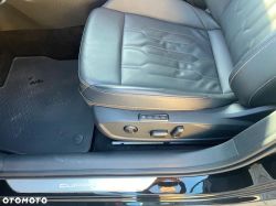 Close-up of a car driver’s seat with electric controls; “CUPRA” text on the door sill.