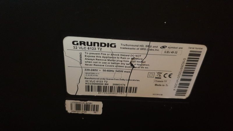 Product label on a Grundig TV, model 32 VLC 6123 T2, with barcodes on a black casing