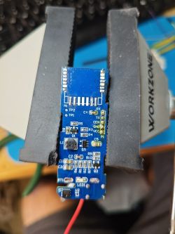 TH01 Device PCB Board in a Vise PCB board with electronic components in a vise.