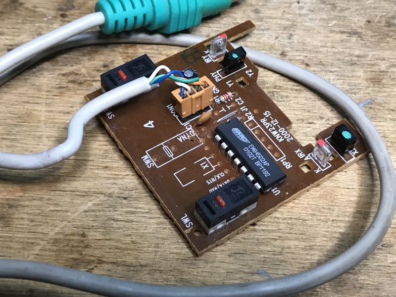 Inside of an Old Computer Mouse Circuit board of an old computer mouse with electronic components.