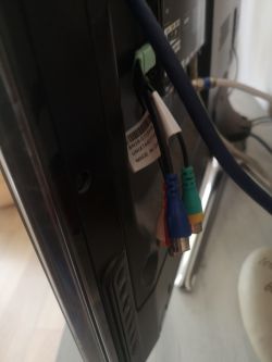 Tył telewizora z podłączonymi kablami RCA i ethernet.
