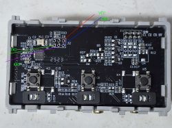 Close-up of a PCB with buttons, connectors, and labeled TXD, RXD, VCC, and GND pins