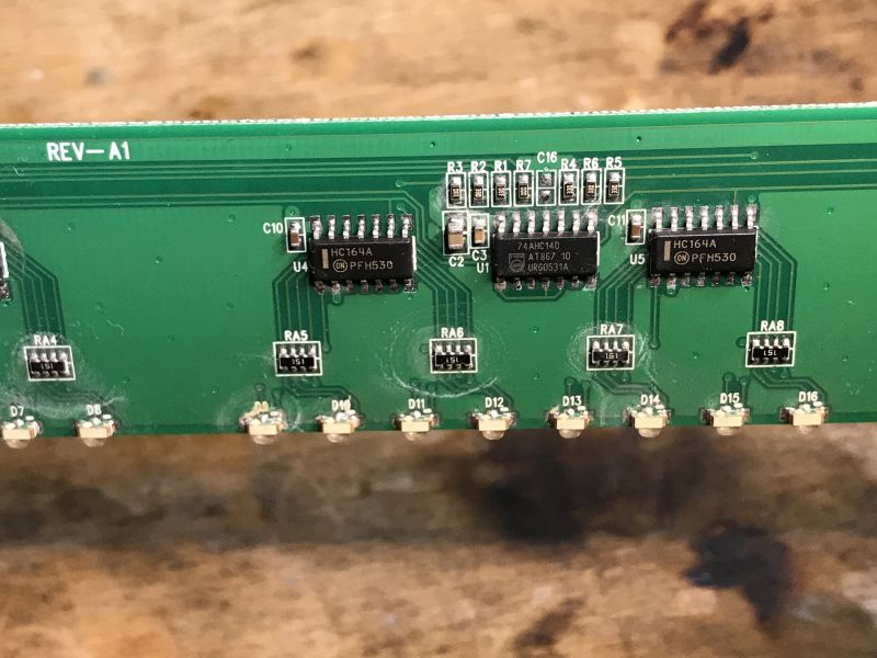PCB with HC164A Shift Registers and 74AHC14D Buffer Printed circuit board with HC164A and 74AHC14D ICs and LEDs.