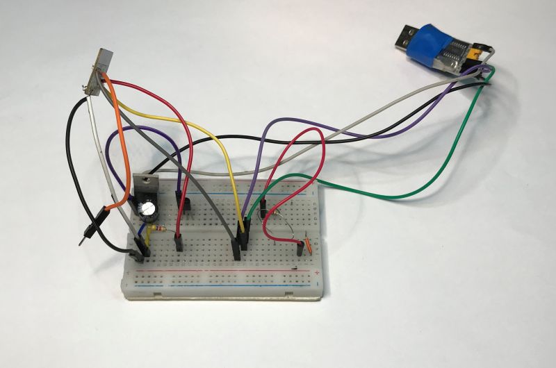 Breadboard with mounted electronic components and multicolored wires.