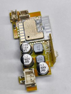 Electronic module with a relay and capacitors on a PCB.