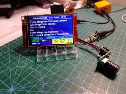 LCD module showing MP3 playback on a cutting mat, with a wired rotary encoder knob beside it